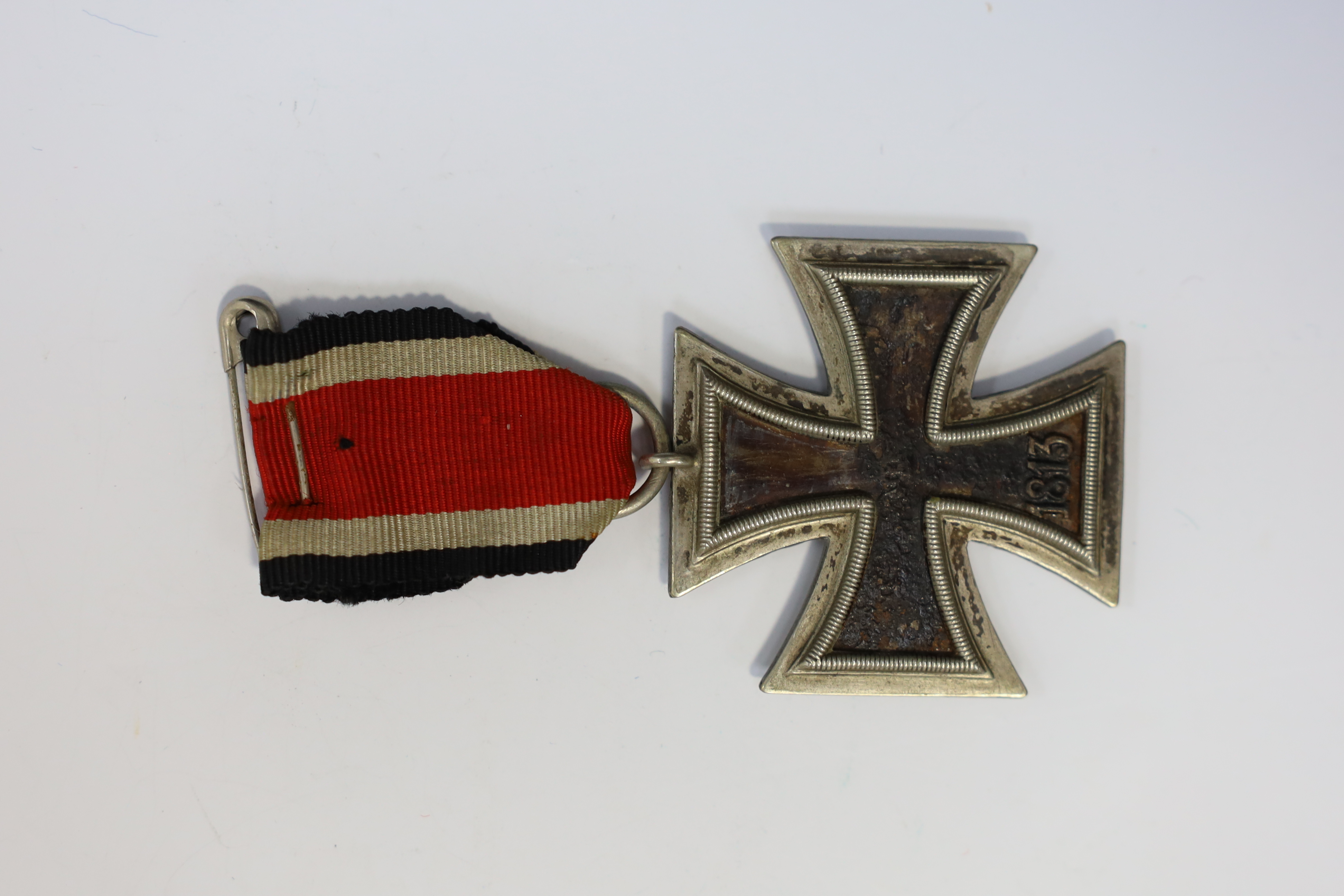 A WWII Iron Cross. Condition - poor, black paint now mainly missing from surface.